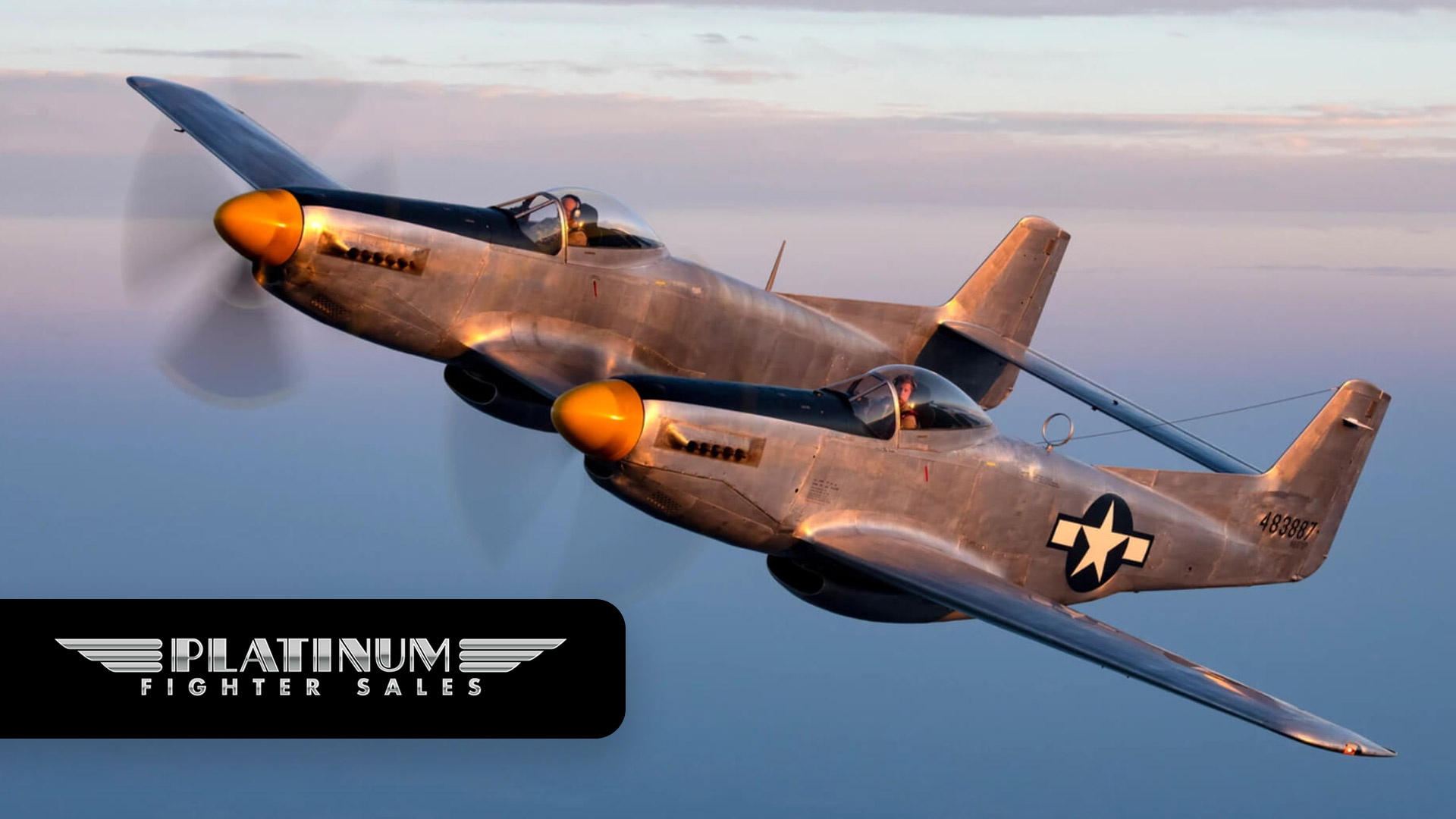 Two vintage fighter planes flying at sunset.