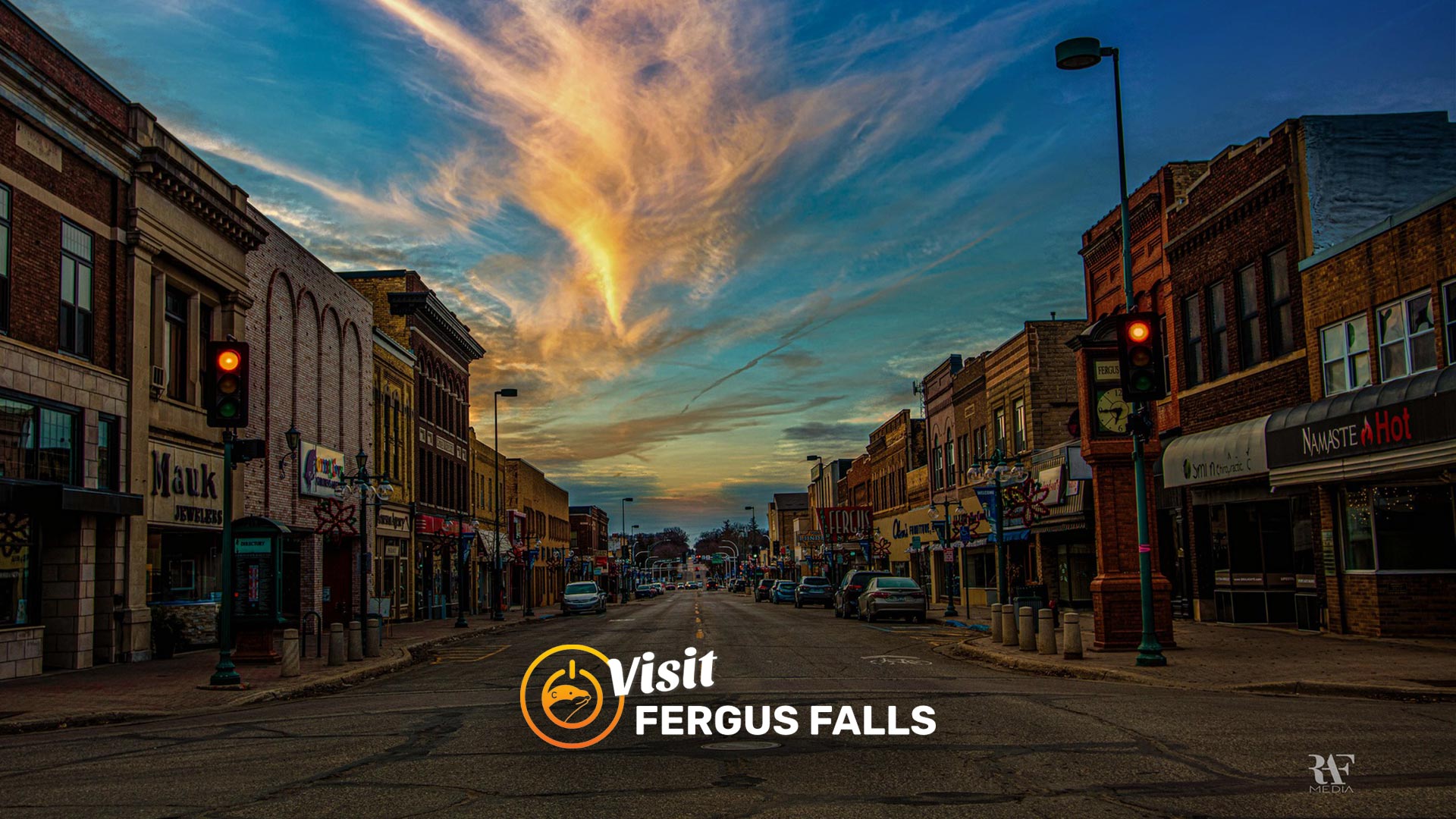 Downtown Fergus Falls at sunset with shops visible.