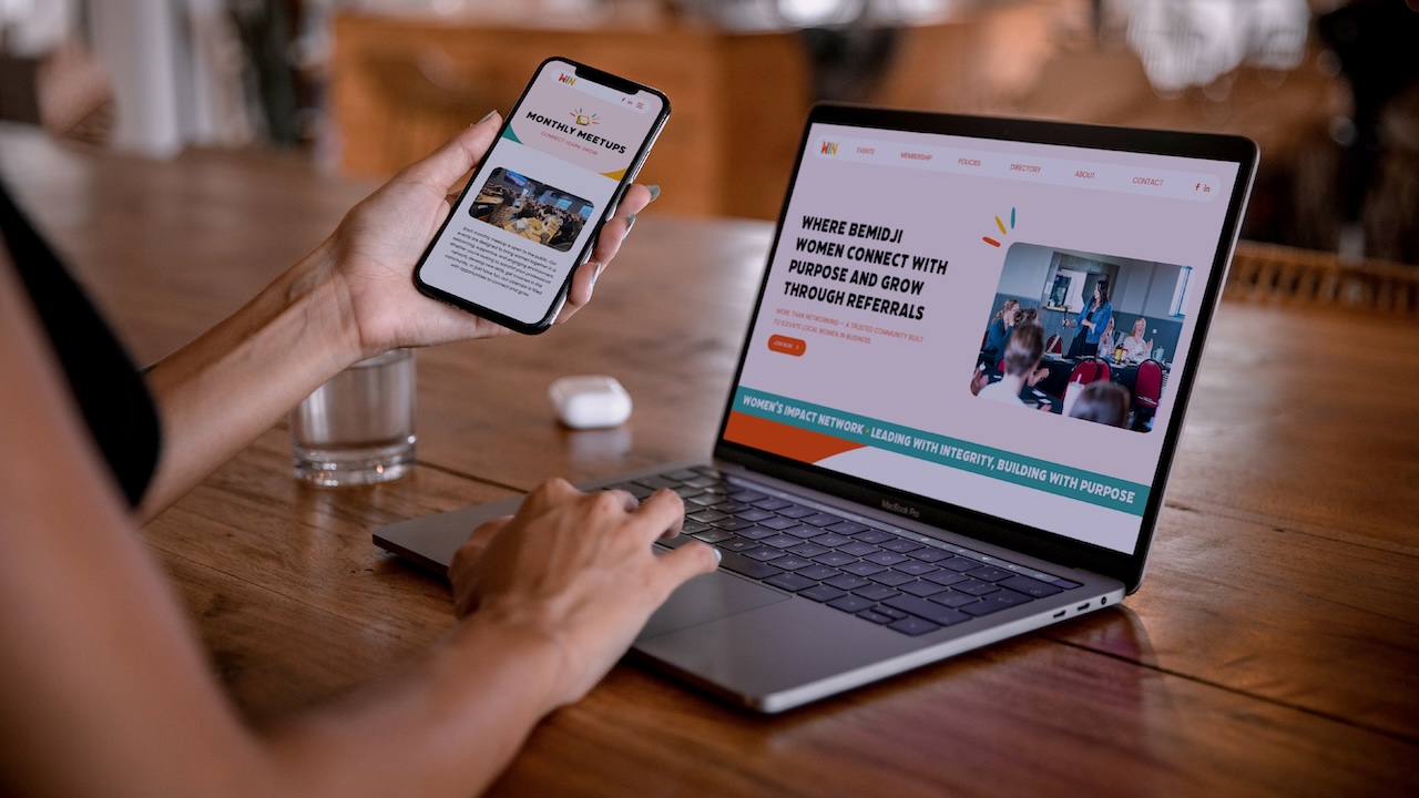 Woman browsing Women's Impact Network website on laptop and phone