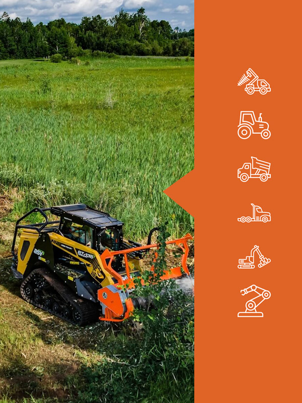 Tracked machine clearing dense greenery in a field.